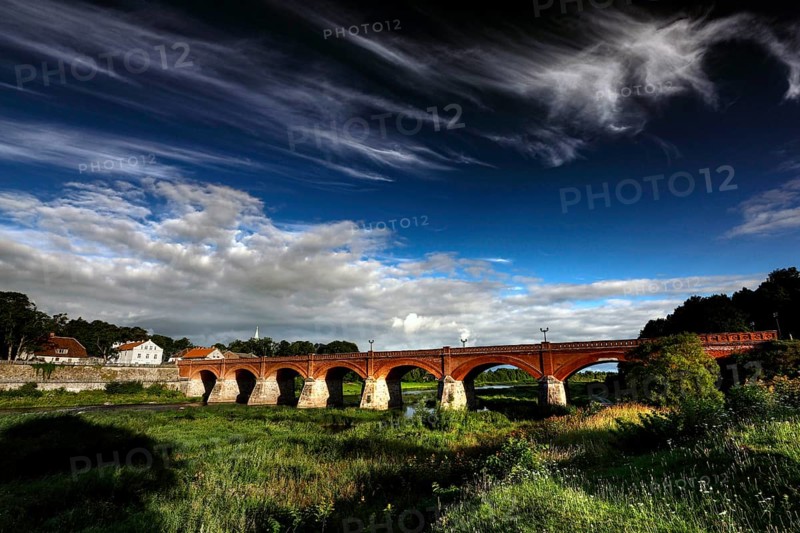 Impressive brick bridge in the Windau valley under a cloudy sky, Kuldiga, Windau, Latvia