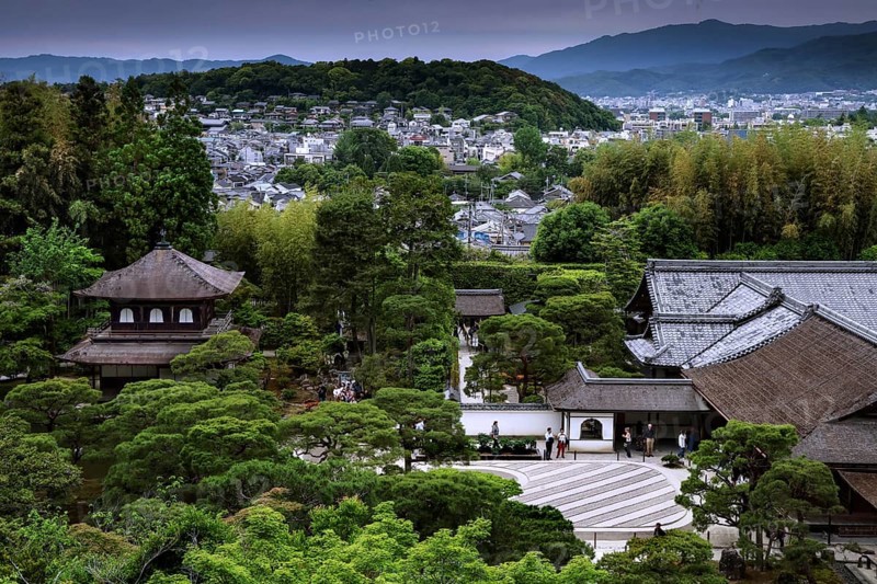 View of the Zen garden of Ginkaku-ji Temple with surrounding forest landscape and mountains in the background, Kyoto, Japan