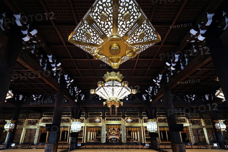 Interior view of Nishi Hongan-ji Temple with impressive chandelier and ornate woodwork, Kyoto, Japan