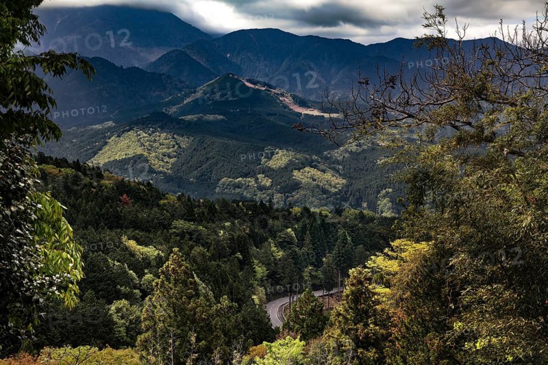 Lush valleys and forests stretch under a cloudy sky, Kiso, Nagano, Japan