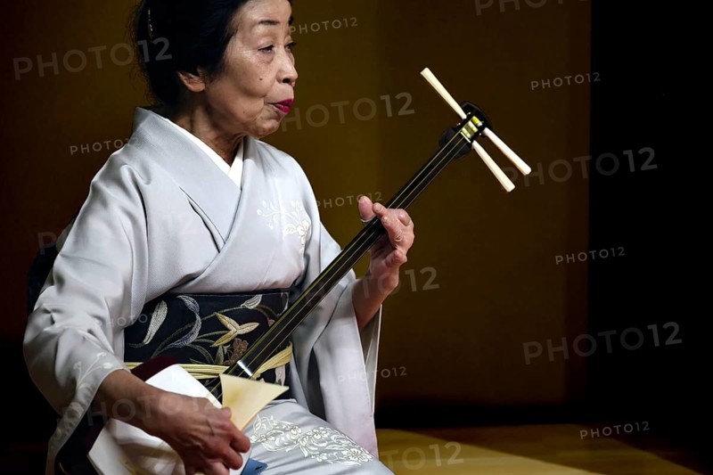 Senior geisha plays Shamisen in the Nishi Chaya tea house district in Kanazawa, Kanazawa, Ishikawa, Japan