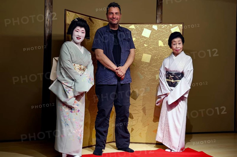 Two geishas and a man pose in the Nishi Chaya tea house district in Kanazawa, Kanazawa, Ishikawa, Japan