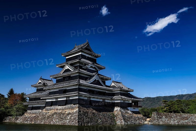 Matsumoto Castle surrounded by water and blue sky, Matsumoto, Nagano, Japan