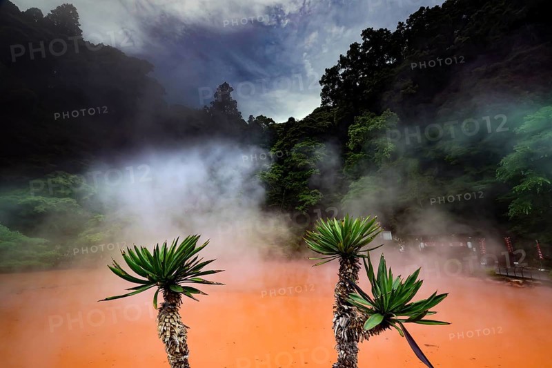Steam rises over the red water of Chinoike Jigoku in Beppu, Beppu, Kyushu, Japan