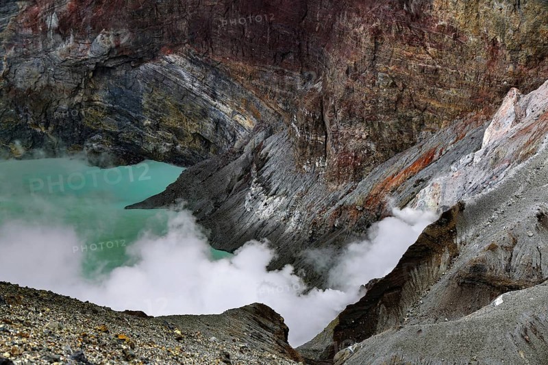 Steaming crater lake with color-varying rock structures, Aso, Kumamoto, Japan