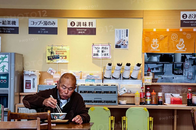 Guest eats ramen at a simple restaurant in Aso, Aso, Japan
