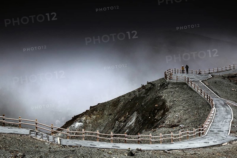 Mystical crater landscape in rain with dramatic sky, Aso, Japan