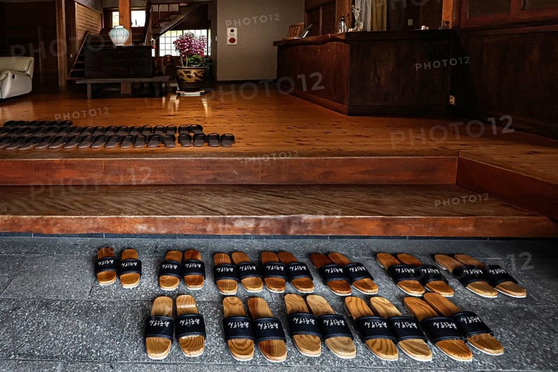 Entrance to Ryokan Minshuku Asogen with carefully arranged shoes