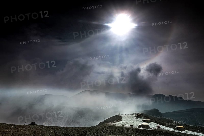 Intense sunlight and fog over the crater and bunker at Nakadake, Aso, Aso, Kyushu, Japan