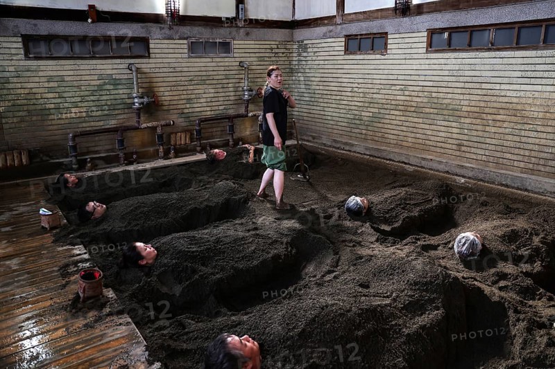 Visitors to Takegawara Onsen are deeply relaxed in sand baths, Beppu, Oita, Japan