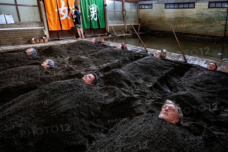 Attendees enjoy a unique sand bath at Takegawara Onsen in Beppu, Beppu, Oita, Japan