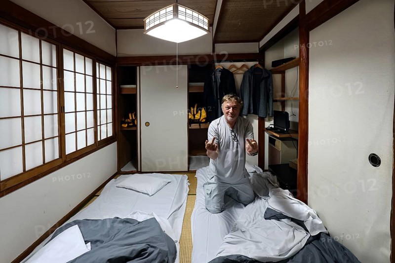 Japanese room with tatami flooring and futons. Guest preparing for overnight stay, Beppu, Oita, Japan