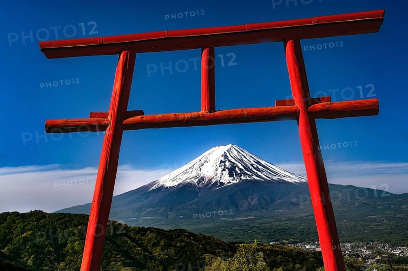 Red torii with a view of snow-capped Mount Fuji in Kawaguchi-ko, Kawaguchi-ko, Yamanashi, Japan