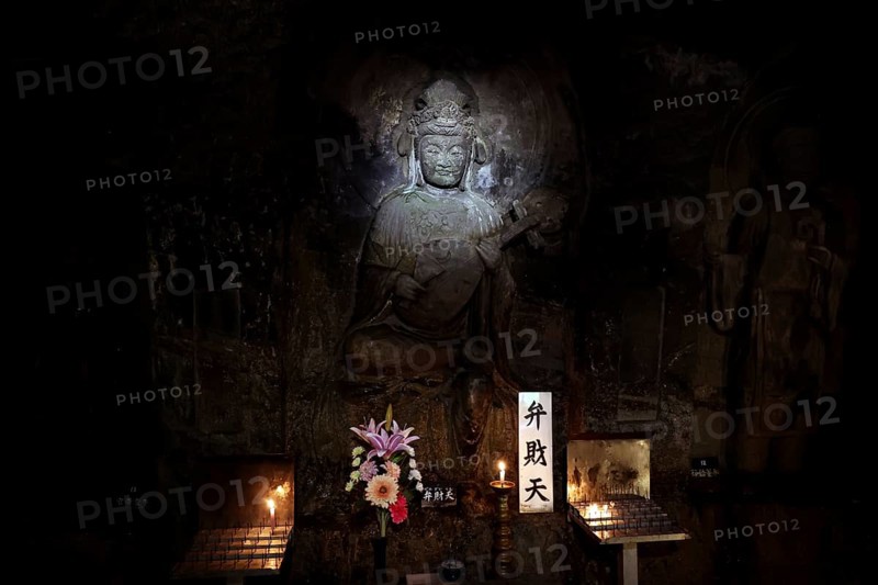 Illuminated Buddha relief in a cave at the Hare Dera Temple in Kamakura, Kamakura, Kanagawa, Japan