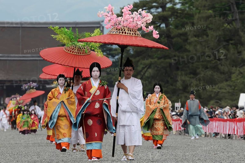 Traditional procession with geishas and red umbrellas during Aoi Matsuri in Kyoto, Kyoto, Japan