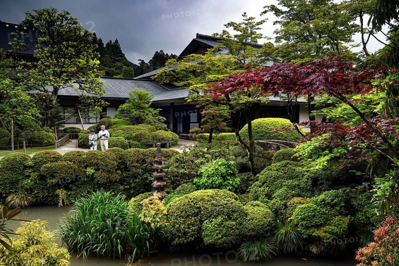 Lush Japanese garden with pagoda and well-kept greenery surrounded by stones, Nikko, Tochigi, Japan