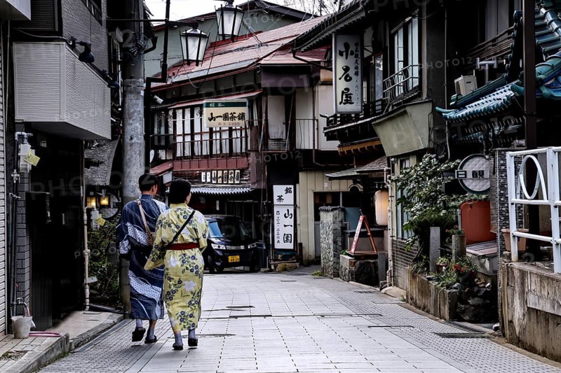 People in Yukata stroll down a traditional street in Yamanouchi, Yamanouchi, Nagano, Japan