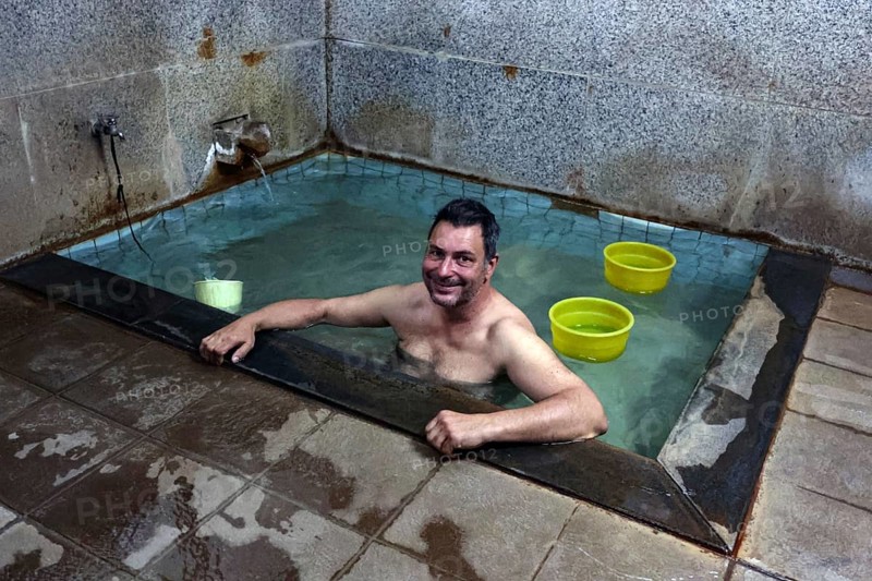 Man relaxing in a traditional public bath in Yamanouchi