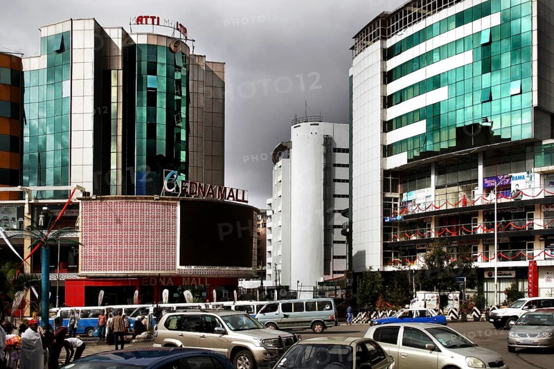 Modern city scene in Addis Ababa with tall buildings and heavy traffic under a cloud-covered atmosphere, Addis Ababa, Ethiopia