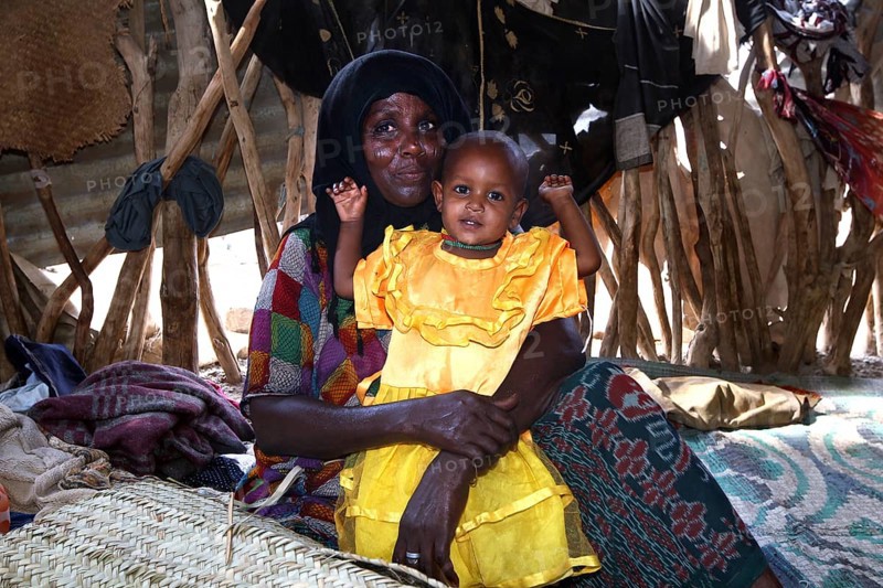 Muhammad's mother lovingly keeps Fatimeh in the hut, Ahmedela, Tigray, Ethiopia