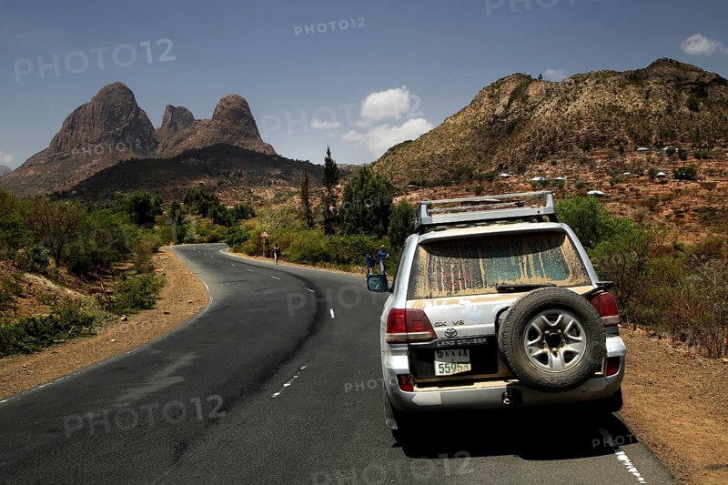 Landcruiser rides on the road with views of the Adua Mountains, Adua, Tigray, Ethiopia