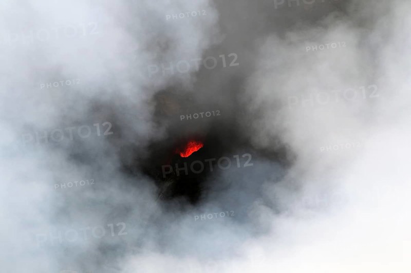 Smouldering volcano with a crater partly covered by haze, Erta Ale, Ethiopia