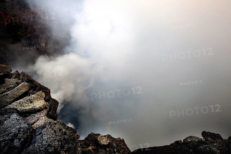 Smoke rises from a volcanic crater and obscures the view, Erta Ale, Ethiopia