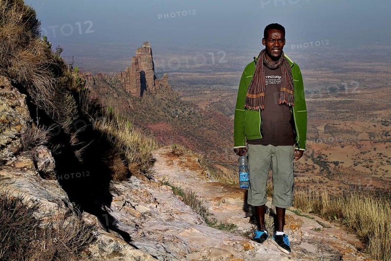 Man climbing the Gheralta Mountains with a wide view over the rocky landscape, zero