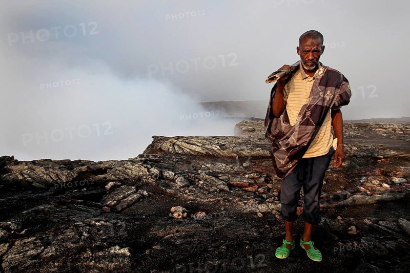 Police officer Muhammed at the edge of the smoking crater of Erta Ale, Erta Ale, Afar, Ethiopia