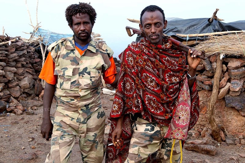 Two soldiers in traditional and military clothing at Erta Ale Camp, Erta Ale, Ethiopia
