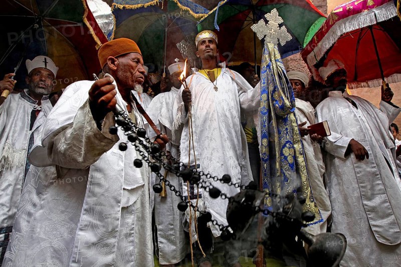 Religious procession with men wearing traditional clothing and crosses, Lalibela, Amhara, Ethiopia