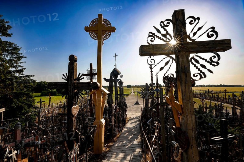 Path through the crosses in evening light on the Hill of Crosses in Siauliai, Siauliai, Lithuania