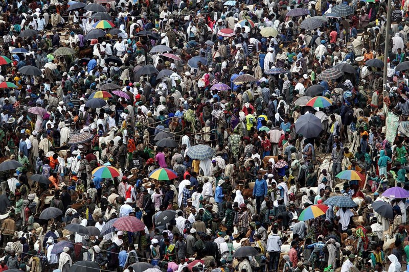 Dense crowd with colorful umbrellas at a busy market, Lalibela, Ethiopia