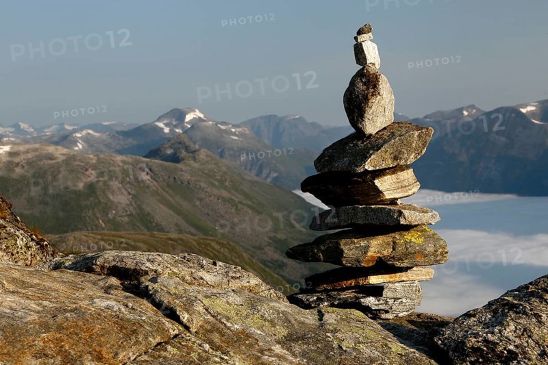 Stone pyramid on a mountain with a wide view over mountain ranges, Geirangerfjord, Dalsnibba, Norway