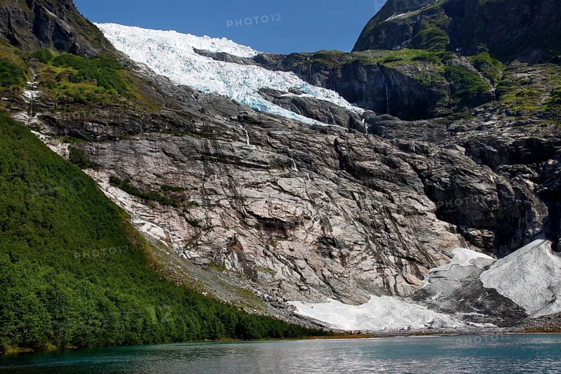 Spectacular Bøyabreen glacier tongue surrounded by steep rocks and green hills, Bøyabreen, Norway