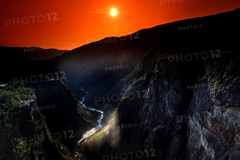 Spectacular view of Vøringsfossen at sunset in Måbødal, surrounded by dramatic rock faces, Eidfjord, Norway