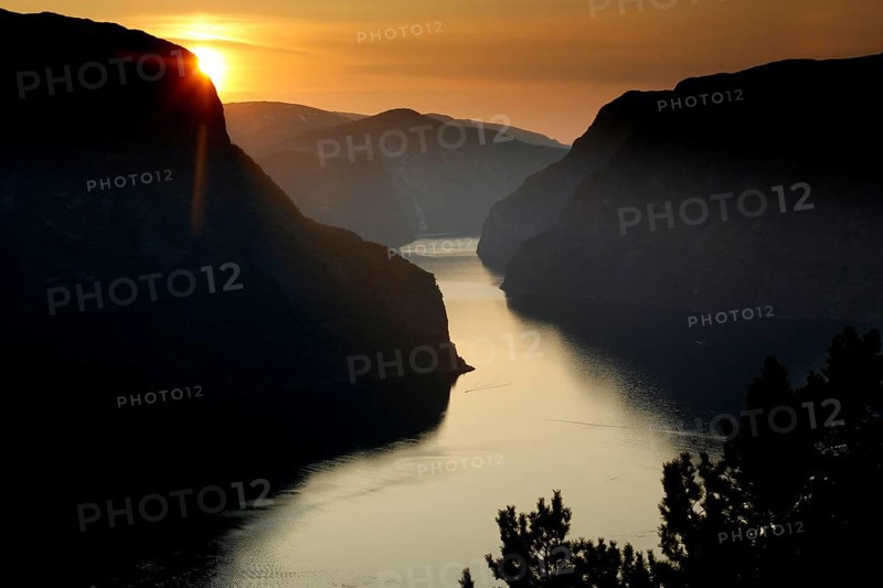 Sunset over Aurlandsfjord from Stegastein viewpoint with dramatic sky, Aurlandsvangen, Norway
