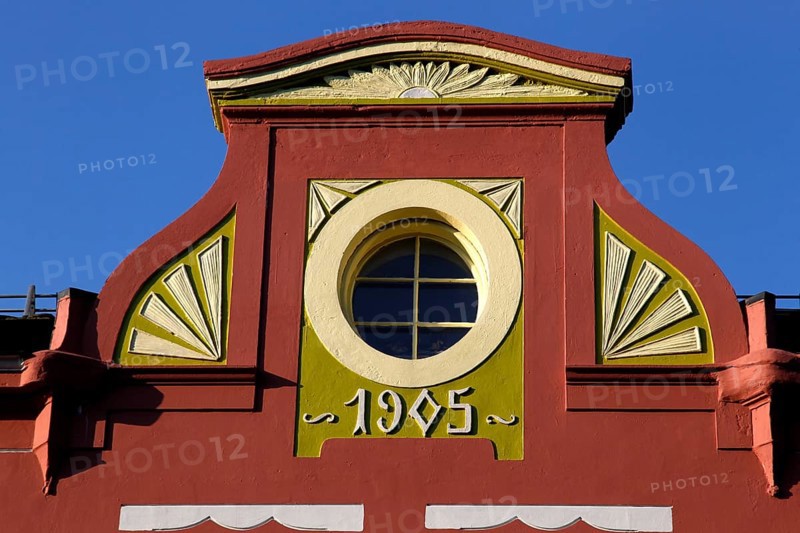 Detail of an Art Nouveau façade in Ålesund with round window opening and decorative ornaments, Ålesund, Møre og Romsdal, Norway