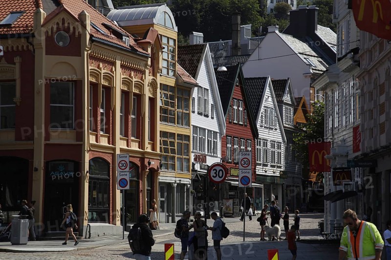 Scenic city view with historic colorful buildings and passers-by, Bergen, Hordaland, Norway