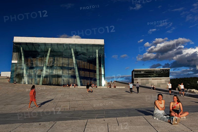 People enjoy sunny day in front of Oslo Opera and Munch Museum, Oslo, Bjøvika, Norway