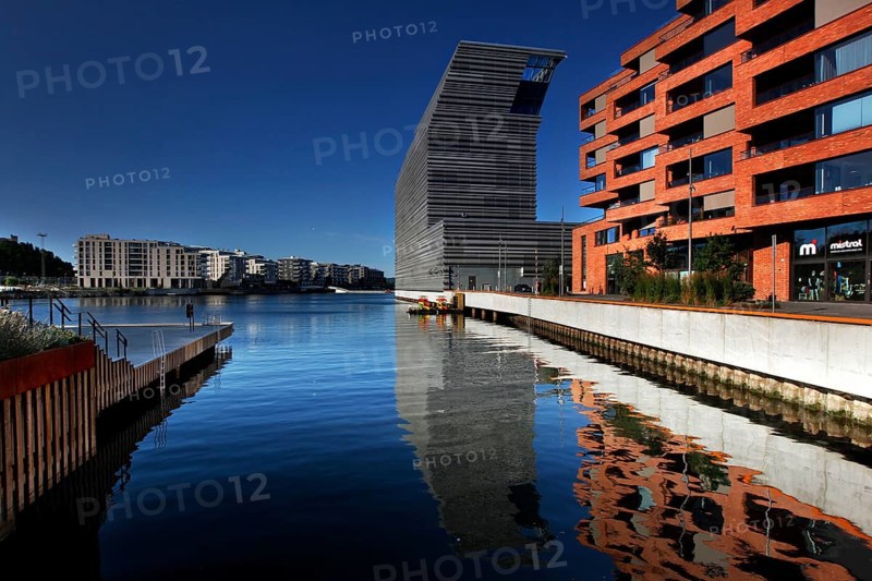 The Munch Museum is reflected in the clear water of Bjøvika in Oslo, Oslo, Bjøvika, Norway