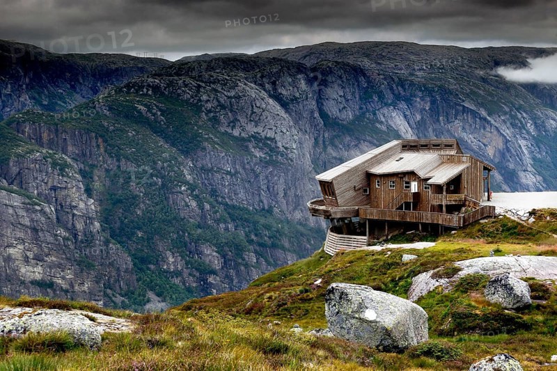 Panoramarestaurant Øygardstølen towers dramatically over the Lysefjord under a grey sky, Lysefjord, Rogaland, Norway