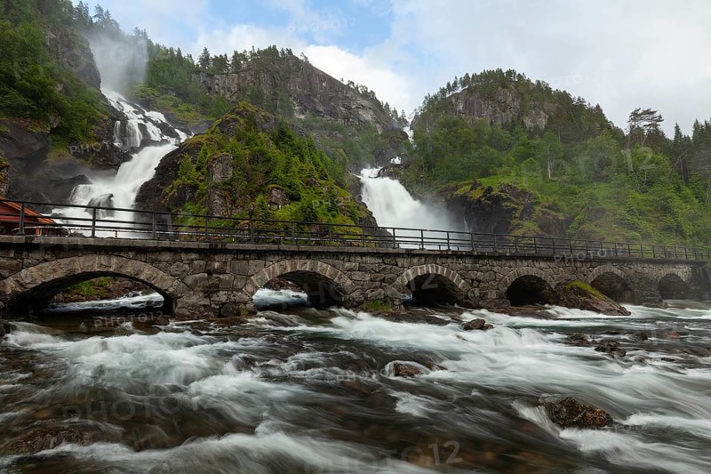 Summer day visiting Låtefossen falls near Odda, flowing water and green valley, Vestland, Norway