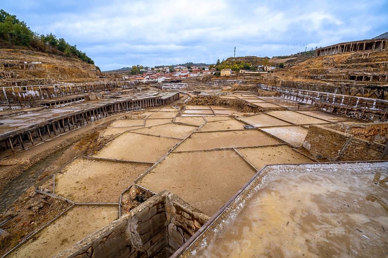 Salt farming terraces and ancient wooden structures fill the historic salt valley of anana, showcasing traditional salt production in the province of alava, spain