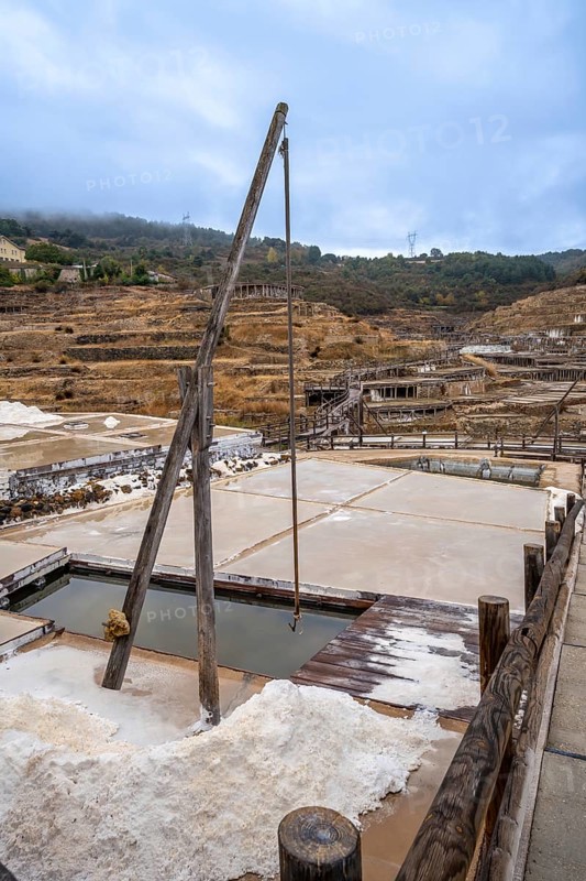 Ancient terraced salt pans extracting salt from brine, showcasing a traditional and historical method of salt production in the salt valley of anana, basque country