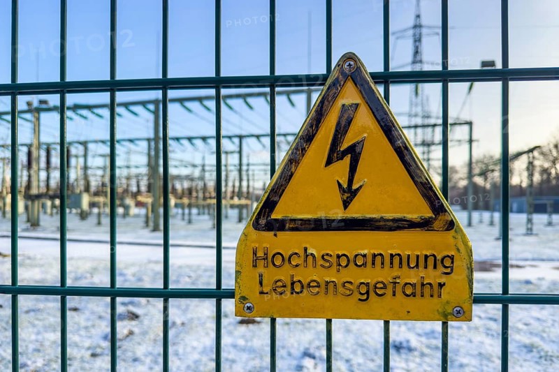 Recording of snow in winter warning sign warning high voltage danger to life on fence from behind substation substation substation substation part of electrical supply network with transformer generator in the background high-voltage lines high-voltage pole for secure energy supply Power supply, Germany