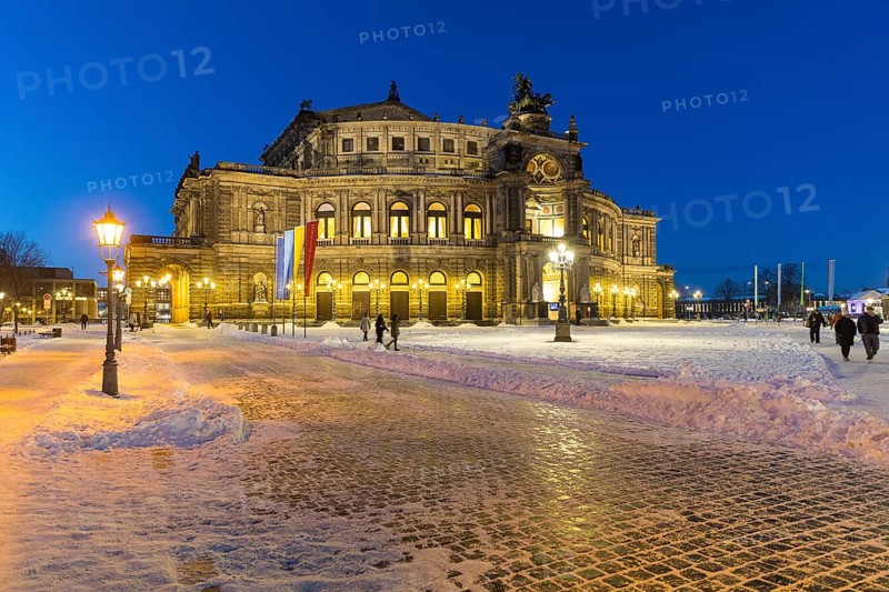 Illuminated Semper Opera House and Theatre Square with snow at dusk, Old Town of Dresden, Saxony, Germany