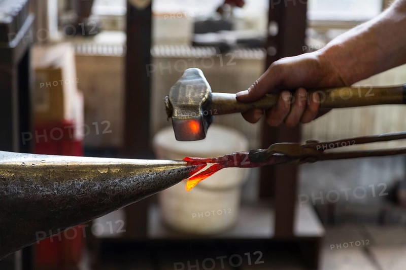 A blacksmith forging, working at the Ehnert forge in Dresden-Bühlau, Saxony, Germany