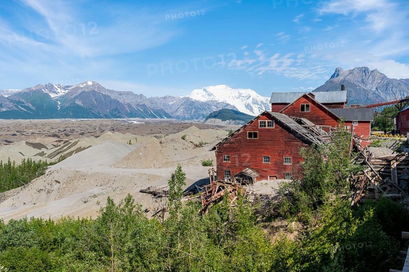Red Kennicott buildings in front of mountainous landscape, Kennicott Concentration Mill to extract copper from quarried rock, Historic Kennecott Copper Mine, National Historic Landmark, Wrangell St. Elias National Park, Alaska, USA
