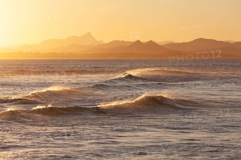 Evening light at Cape Byron with view to Mount Warning and sunlit hinterland, New South Wales, Australia